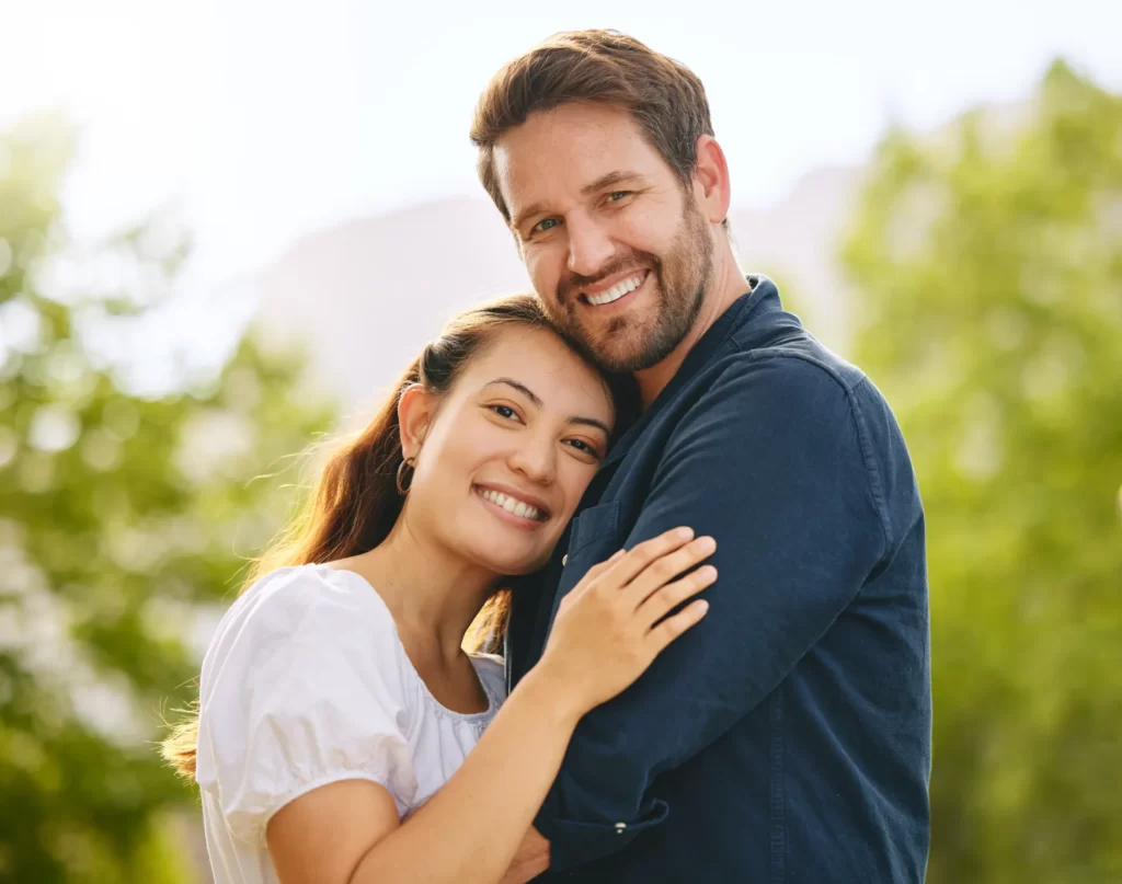 couple embracing in warm sunlight in a green space utc ()