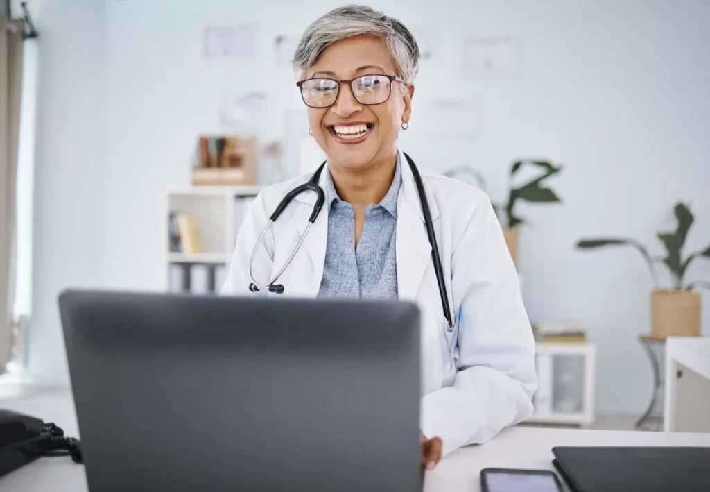 woman doctor laptop and happy in hospital office utc ()